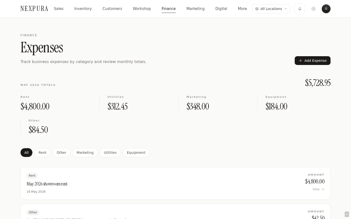 /expenses — month label at the top (e.g. May 2026), eight category total cells with current-month spend per category, month total, list of expenses below with columns Description / Category / Amount / Date / Receipt indicator / actions. New Expense button top-right.